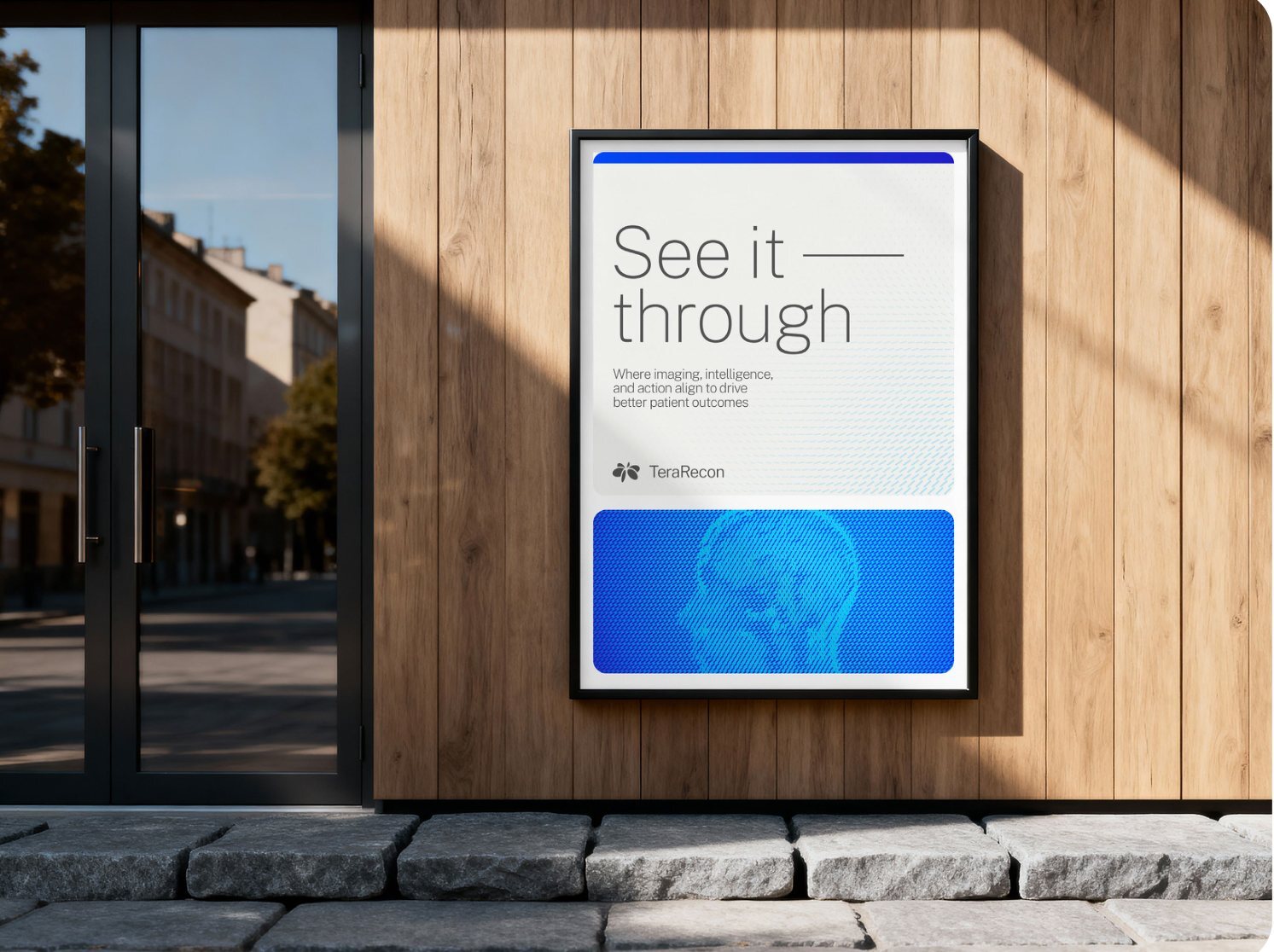 Framed poster on a wooden wall: See it through over pale particle flow, a Cobalt edge strip along the top, the Charcoal lockup, and a skull particle-flow card on Cobalt